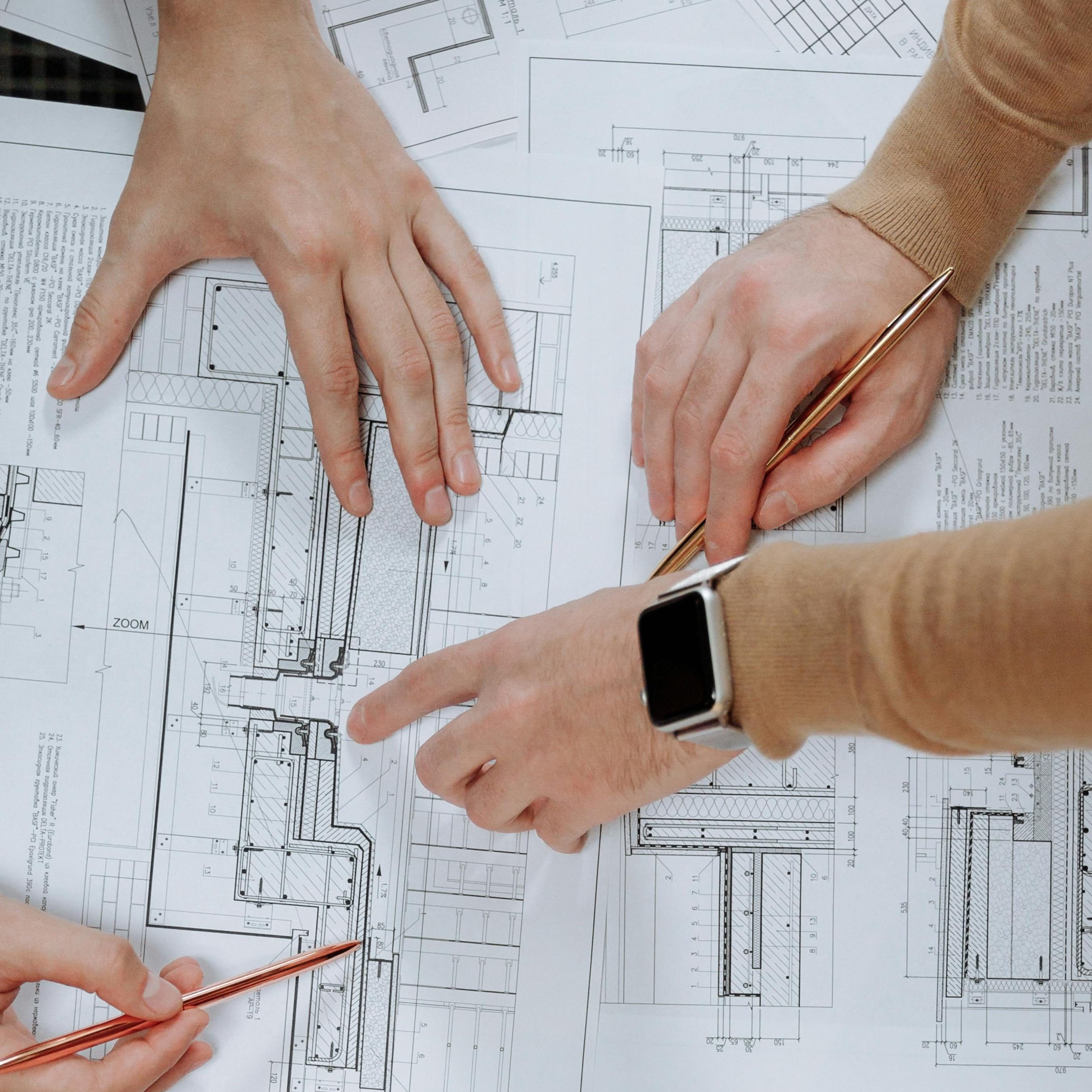 Drafting hands over architectural plans